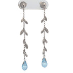14K white gold, diamond, and blue topaz earrings.